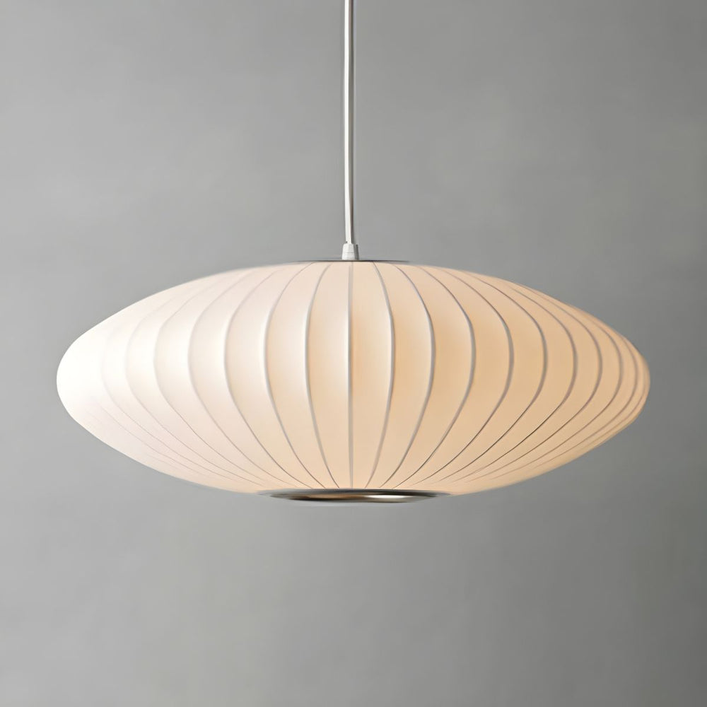 Minimalist indoor disk-shaped silk pendant lighting illuminating a modern room.